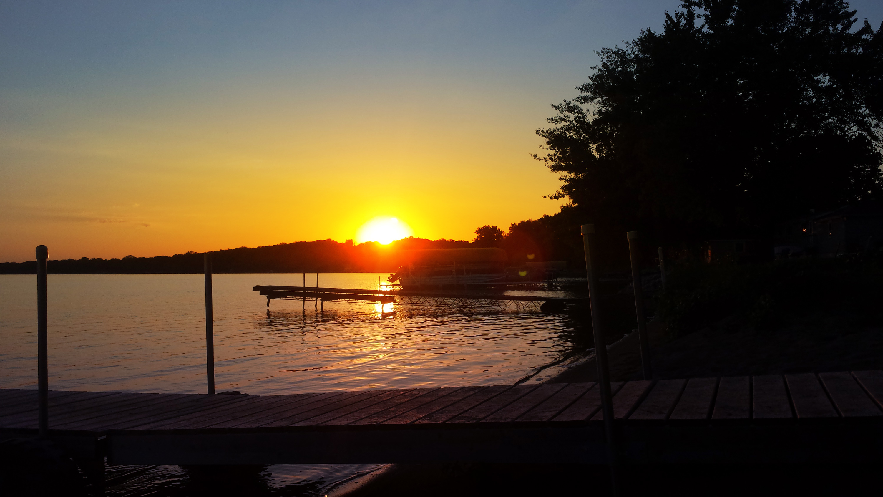 Sunset across the lake dock